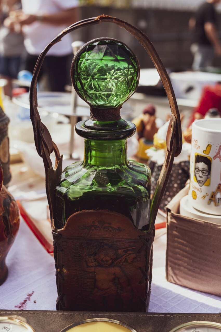 old beautiful green glass bottle on a flea market