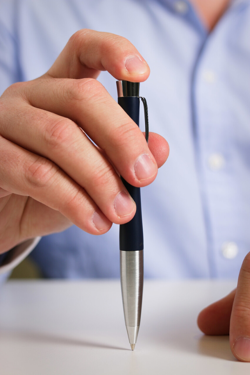 businessman with pen in hand