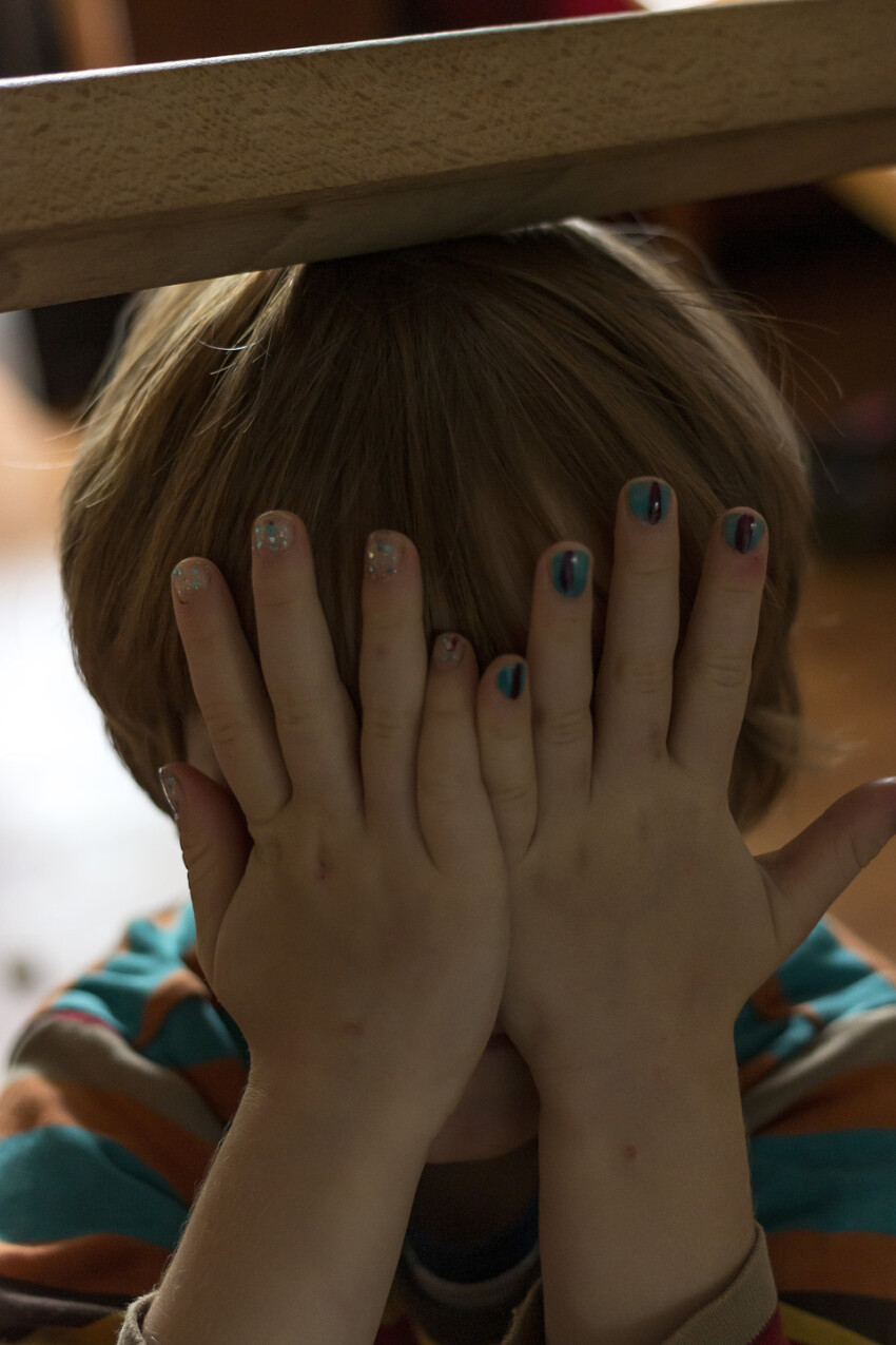 child with nail polish finger