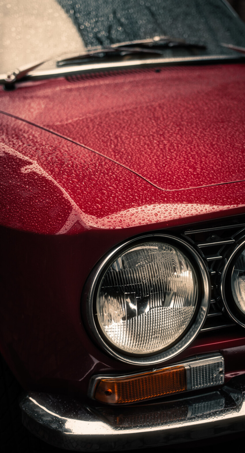 Headlights , radiator and hood of retro red car