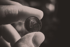 Stock Image: 1 euro cent between fingers