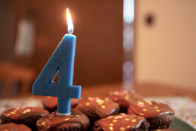 Stock Image: 4th birthday candle on muffins