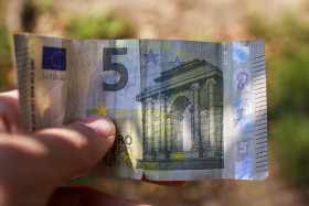 Stock Image: 5 euros in man hand