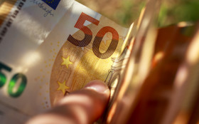 Stock Image: 50 euro money banknotes in a hand background