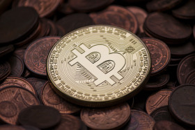 Stock Image: a bitcoin between euro coins