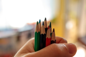 Stock Image: A pile of crayons firmly in hand