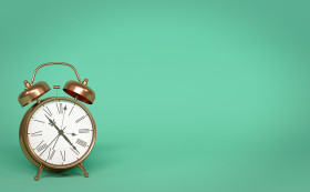 Stock Image: alarm clock isolated on green background