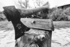 Stock Image: Ax stuck in block of wood