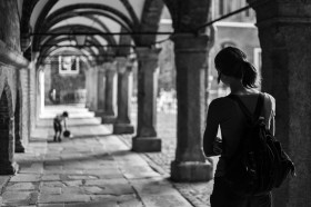 Stock Image: back view of a female tourist in lubeck black and white