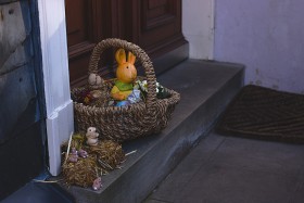 Stock Image: Basket filled with Easter decorations on a doorstep