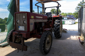 Stock Image: beautiful red vintage tractor on a farm