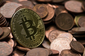 Stock Image: Bitcoin between euro coins