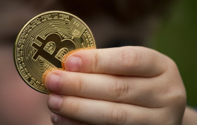 Stock Image: bitcoin in childrens hand