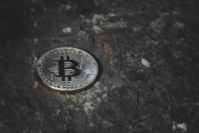 Stock Image: bitcoin on dark stone background