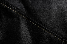 Stock Image: Black leather texture background with seam