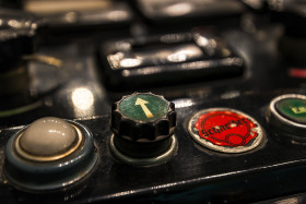 Stock Image: black old vintage control panel with a lot of buttons