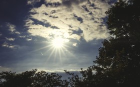Stock Image: Blue cloudy sky with sun