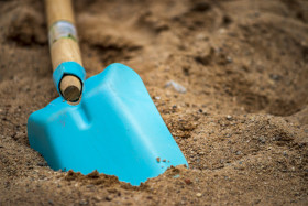 Stock Image: Blue Shovel in Sand