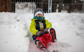 Stock Image: Boy dashes through snow with a sledge