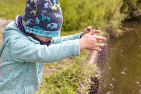 Stock Image: Boy drops sand