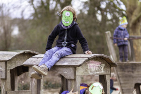 Stock Image: boy with monster mask playing on playground
