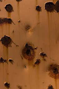 Stock Image: brown rusty steel texture with holes