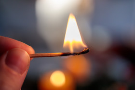 Stock Image: Burning match in the hand