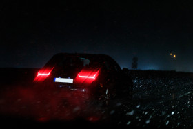 Stock Image: Car drives through snowstorm on motorway