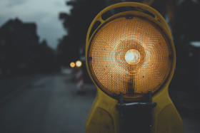 Stock Image: Caution yellow light in the city