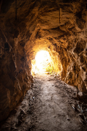 Stock Image: Cave with light at the end of the tunnel