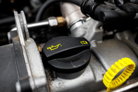 Stock Image: Changing automobile motor oil on the car