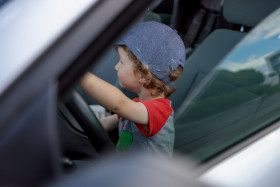 Stock Image: Child drives a real car