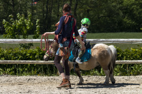 Stock Image: child is riding a pony