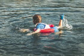 Stock Image: child is swimming in the lake