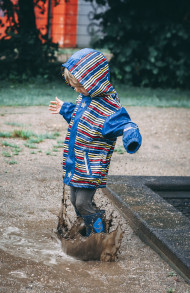 Stock Image: child jumps in a mud puddle