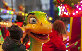 Stock Image: Child on a carousel with cars at a Christmas market in Germany