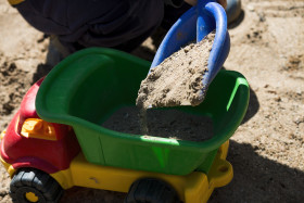 Stock Image: child plays with toy tipper