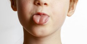 Stock Image: Child shows the tongue