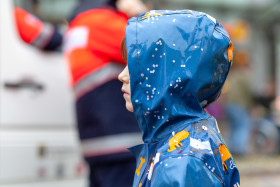 Stock Image: Child stands in the rain