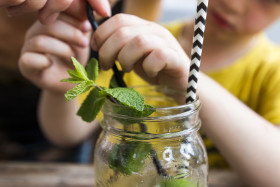 Stock Image: Child with an ice tea - Summerdrink