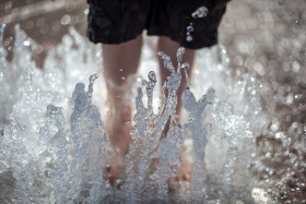 Stock Image: Child with feet in the fountain