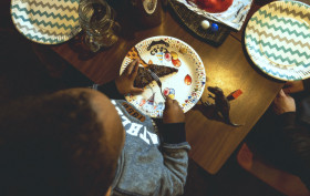 Stock Image: children birthday party boy eats cake