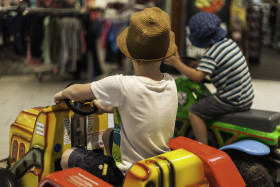 Stock Image: children in the department store on a vending machine carousel