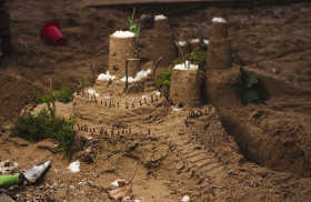 Stock Image: Children playing with sand building a castle