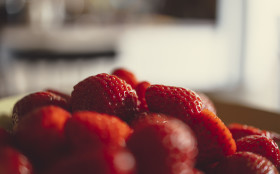 Stock Image: Close up view of strawberries on a plate in a modern kitchen