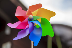 Stock Image: Colourful pinwheel toy in a garden