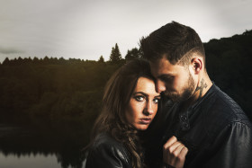 Stock Image: couple cuddles by the lake