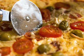 Stock Image: cut cheesy pizza