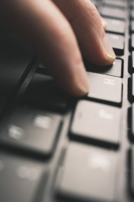 Stock Image: Detailed view of man is tipping on a computer keyboard