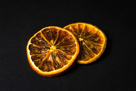 Stock Image: dried orange slices black background